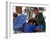 A Mother Watches as Her Child Gets a Haircut in the Center of Kabul, Afghanistan on Oct. 9, 2003.-null-Framed Photographic Print