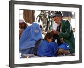 A Mother Watches as Her Child Gets a Haircut in the Center of Kabul, Afghanistan on Oct. 9, 2003.-null-Framed Photographic Print