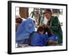 A Mother Watches as Her Child Gets a Haircut in the Center of Kabul, Afghanistan on Oct. 9, 2003.-null-Framed Photographic Print