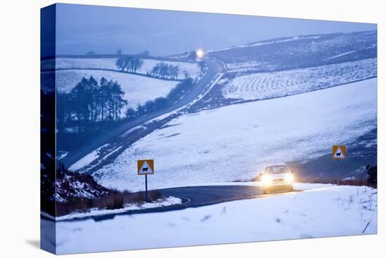 A Motorist Drives Through a Wintry Landscape on the B4520-Graham Lawrence-Stretched Canvas