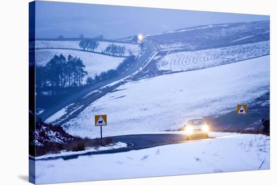 A Motorist Drives Through a Wintry Landscape on the B4520-Graham Lawrence-Stretched Canvas