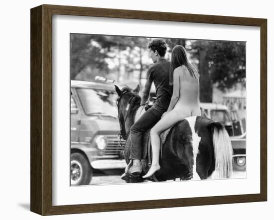 A Naked Young Women and Escort Ride a Horse Through Goose Lake Park at 3 Day Rock Music Festival-null-Framed Photo