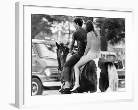 A Naked Young Women and Escort Ride a Horse Through Goose Lake Park at 3 Day Rock Music Festival-null-Framed Photo