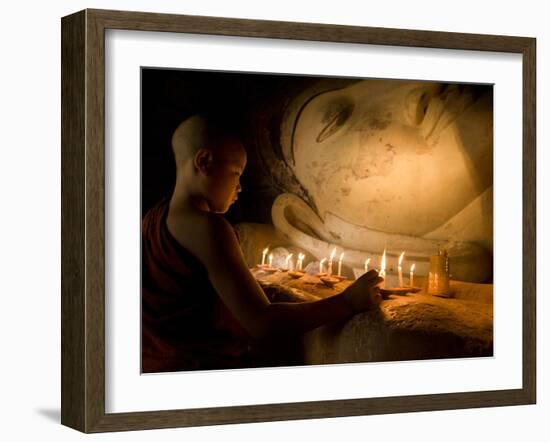 A Novice Monk Lighting Candles at a Massive Buddha Statue in Burma (Myanmar)-Kyle Hammons-Framed Photographic Print