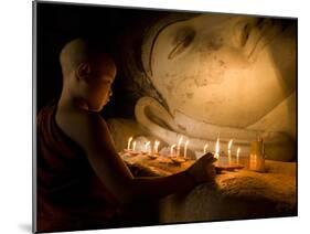 A Novice Monk Lighting Candles at a Massive Buddha Statue in Burma (Myanmar)-Kyle Hammons-Mounted Photographic Print