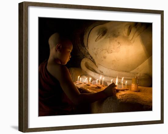 A Novice Monk Lighting Candles at a Massive Buddha Statue in Burma (Myanmar)-Kyle Hammons-Framed Photographic Print