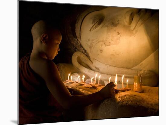 A Novice Monk Lighting Candles at a Massive Buddha Statue in Burma (Myanmar)-Kyle Hammons-Mounted Photographic Print