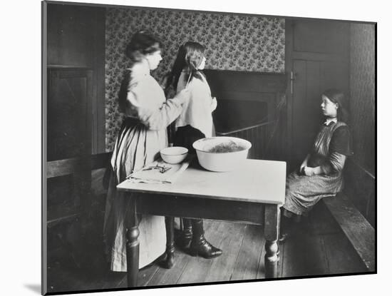 A Nurse Examines Girls Hair, Central Street Cleansing Station, London, 1914-null-Mounted Premium Photographic Print