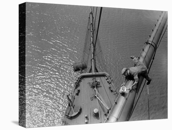 A Painter Lays Across the Rigging While Painting on Sailing Ship-null-Stretched Canvas