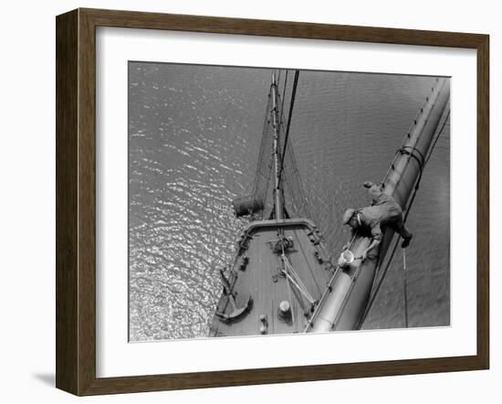 A Painter Lays Across the Rigging While Painting on Sailing Ship-null-Framed Premium Photographic Print