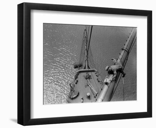 A Painter Lays Across the Rigging While Painting on Sailing Ship-null-Framed Photographic Print