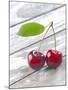 A Pair of Cherries with a Leaf on a Wooden Table-Jürgen Klemme-Mounted Photographic Print