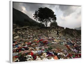 A Pakistani Refugee Walks Past Clothing Left Strewn on the Ground-null-Framed Photographic Print