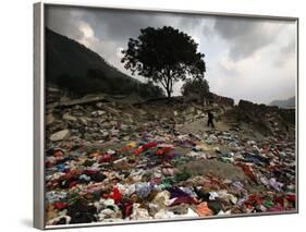 A Pakistani Refugee Walks Past Clothing Left Strewn on the Ground-null-Framed Photographic Print