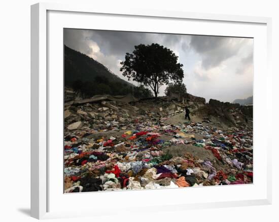 A Pakistani Refugee Walks Past Clothing Left Strewn on the Ground-null-Framed Photographic Print