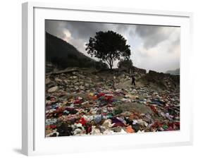 A Pakistani Refugee Walks Past Clothing Left Strewn on the Ground-null-Framed Photographic Print