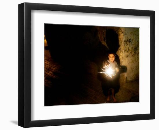 A Palestinian Boy Holds a Sparkler after Breaking the Fast on the First Day of Ramadan in Gaza City-null-Framed Photographic Print