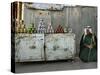 A Palestinian Sits Near the Stand of a Street Seller Displaying Goods for Sale-null-Stretched Canvas