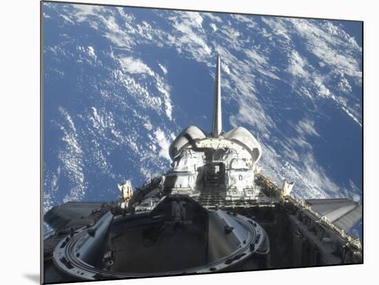 A Partial View of Space Shuttle Atlantis Backdropped by a Blue and White Earth-null-Mounted Photographic Print