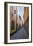 A pedestrian walks the streets of Stockholm's colorful and historic Gamla Stan district, Stockholm,-Jon Reaves-Framed Photographic Print