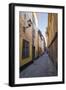 A pedestrian walks the streets of Stockholm's colorful and historic Gamla Stan district, Stockholm,-Jon Reaves-Framed Photographic Print