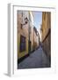 A pedestrian walks the streets of Stockholm's colorful and historic Gamla Stan district, Stockholm,-Jon Reaves-Framed Photographic Print