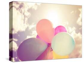 A Person Holding Multi Colored Balloons Done with a Retro Vintage Instagram Filter Effect-graphicphoto-Stretched Canvas