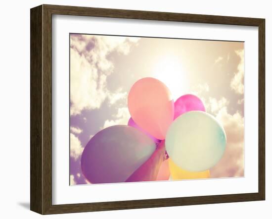 A Person Holding Multi Colored Balloons Done with a Retro Vintage Instagram Filter Effect-graphicphoto-Framed Photographic Print