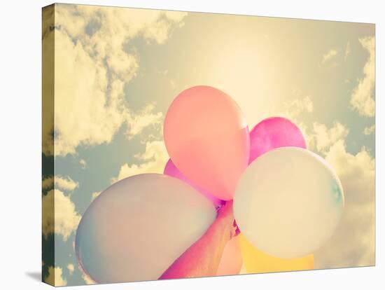 A Person Holding Multi Colored Balloons Done with a Retro Vintage Instagram Filter-graphicphoto-Stretched Canvas