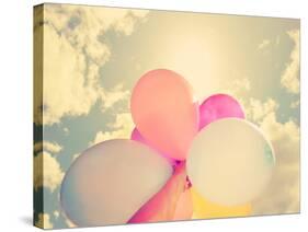 A Person Holding Multi Colored Balloons Done with a Retro Vintage Instagram Filter-graphicphoto-Stretched Canvas