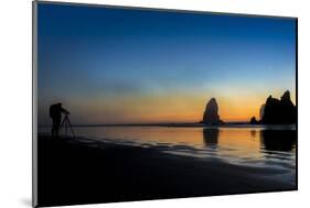 A Photographer Checks His Camera While Photographing the Sunset, Cannon Beach, Oregon-Ben Coffman-Mounted Photographic Print