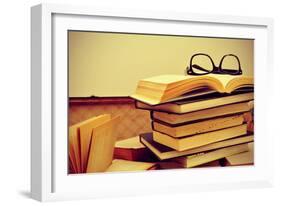 A Pile of Books and a Pair of Eyeglasses in an Old Suitcase, with a Retro Effect-nito-Framed Photographic Print