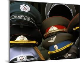 A Pile of Communist Era Army and Police Hats for Sale as Souvenirs, Mitte, Berlin, Germany-Richard Nebesky-Mounted Photographic Print