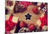 A Pile of Gifts and Christmas Ornaments, such as Christmas Balls and Stars, on a Rustic Wooden Tabl-nito-Mounted Premium Photographic Print