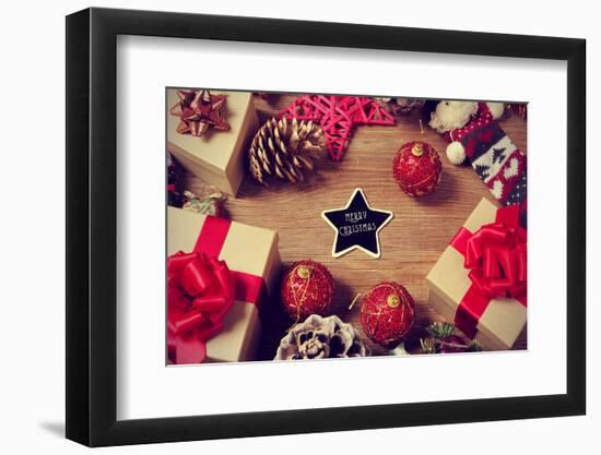 A Pile of Gifts and Christmas Ornaments, such as Christmas Balls and Stars, on a Rustic Wooden Tabl-nito-Framed Photographic Print