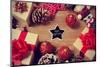 A Pile of Gifts and Christmas Ornaments, such as Christmas Balls and Stars, on a Rustic Wooden Tabl-nito-Mounted Photographic Print