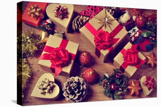 A Pile of Gifts and Christmas Ornaments, such as Christmas Balls, Stars and Tinsel, on a Rustic Woo-nito-Stretched Canvas