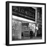 A Policeman Stands in Front of a Pawn Shop-null-Framed Photographic Print