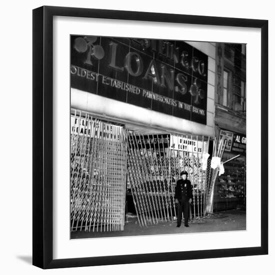 A Policeman Stands in Front of a Pawn Shop-null-Framed Photographic Print