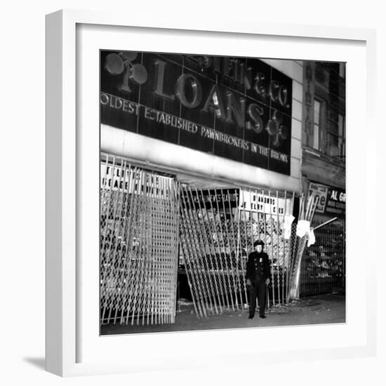 A Policeman Stands in Front of a Pawn Shop-null-Framed Photographic Print