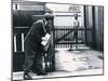 A Postman Hides Behind a Wall, Scared of a Great Dane Dog Leaning on the Fence of the House-null-Mounted Photographic Print