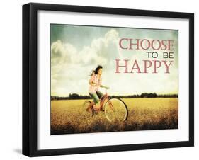 A Pretty Girl Riding through a Field Full of Yellow Flowers with the Text: Choose to Be Happy-graphicphoto-Framed Photographic Print