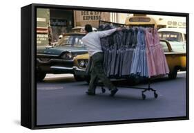 A Push Boy Steers a Rack of Dresses across an Intersection, New York, New York, 1960-Walter Sanders-Framed Stretched Canvas