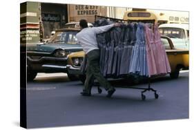 A Push Boy Steers a Rack of Dresses across an Intersection, New York, New York, 1960-Walter Sanders-Stretched Canvas