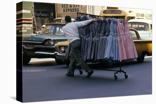 A Push Boy Steers a Rack of Dresses across an Intersection, New York, New York, 1960-Walter Sanders-Stretched Canvas