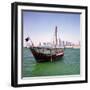 A Qatari Sailing Dhow, Called a Boom or Boum, with the National Flag Flying and the Doha Skyline-PaulCowan-Framed Photographic Print