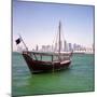 A Qatari Sailing Dhow, Called a Boom or Boum, with the National Flag Flying and the Doha Skyline-PaulCowan-Mounted Photographic Print