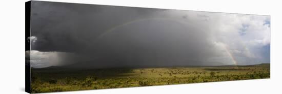 A rainbow over the savannah, Tsavo, Kenya.-Sergio Pitamitz-Stretched Canvas