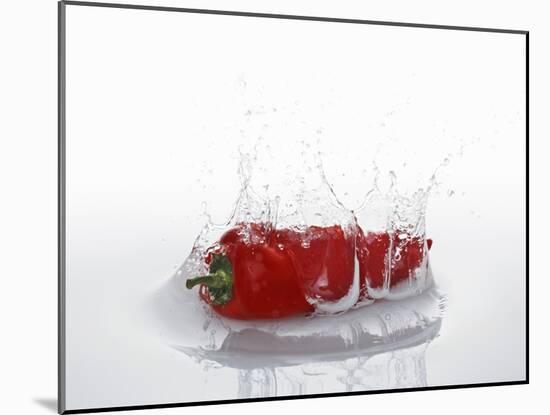 A Red Chilli Pepper Falling into Water-Kröger & Gross-Mounted Photographic Print