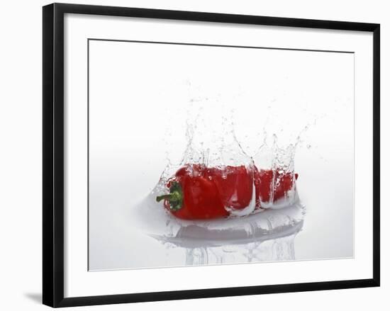 A Red Chilli Pepper Falling into Water-Kröger & Gross-Framed Photographic Print